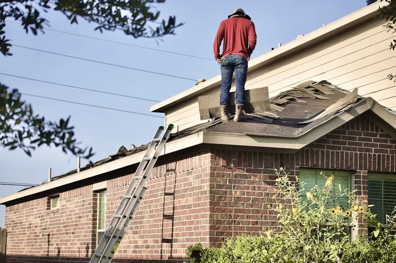 Professional roofer working on a residential roof in Lakewood Hills